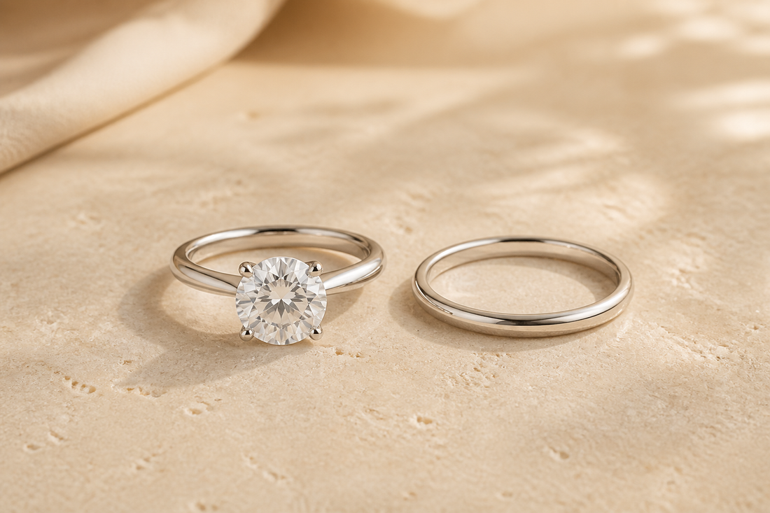 Engagement ring and wedding band compared on warm ivory stone