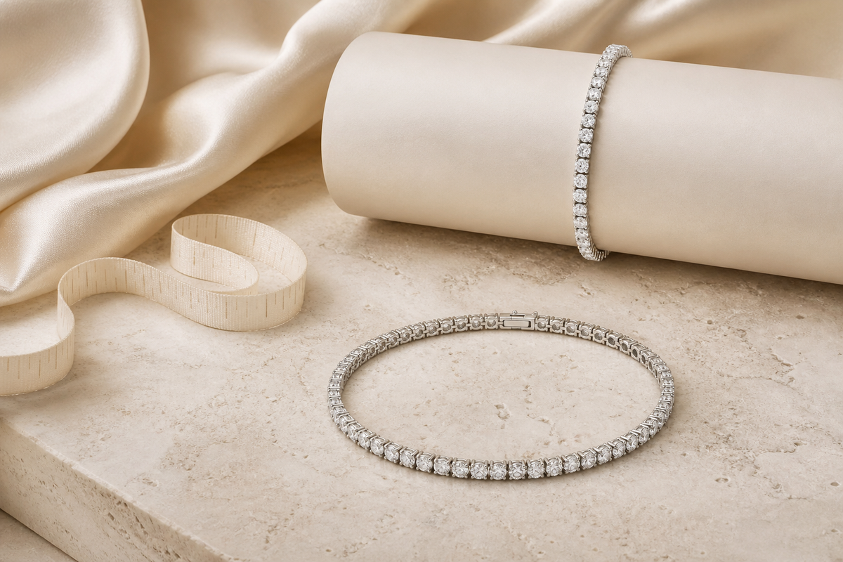 Tennis bracelet displayed with a soft measuring ribbon on warm ivory stone