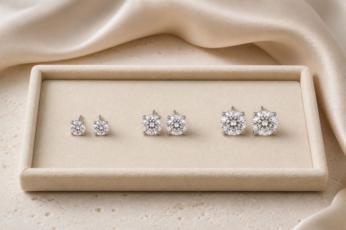 Three pairs of round moissanite stud earrings arranged from petite to statement size