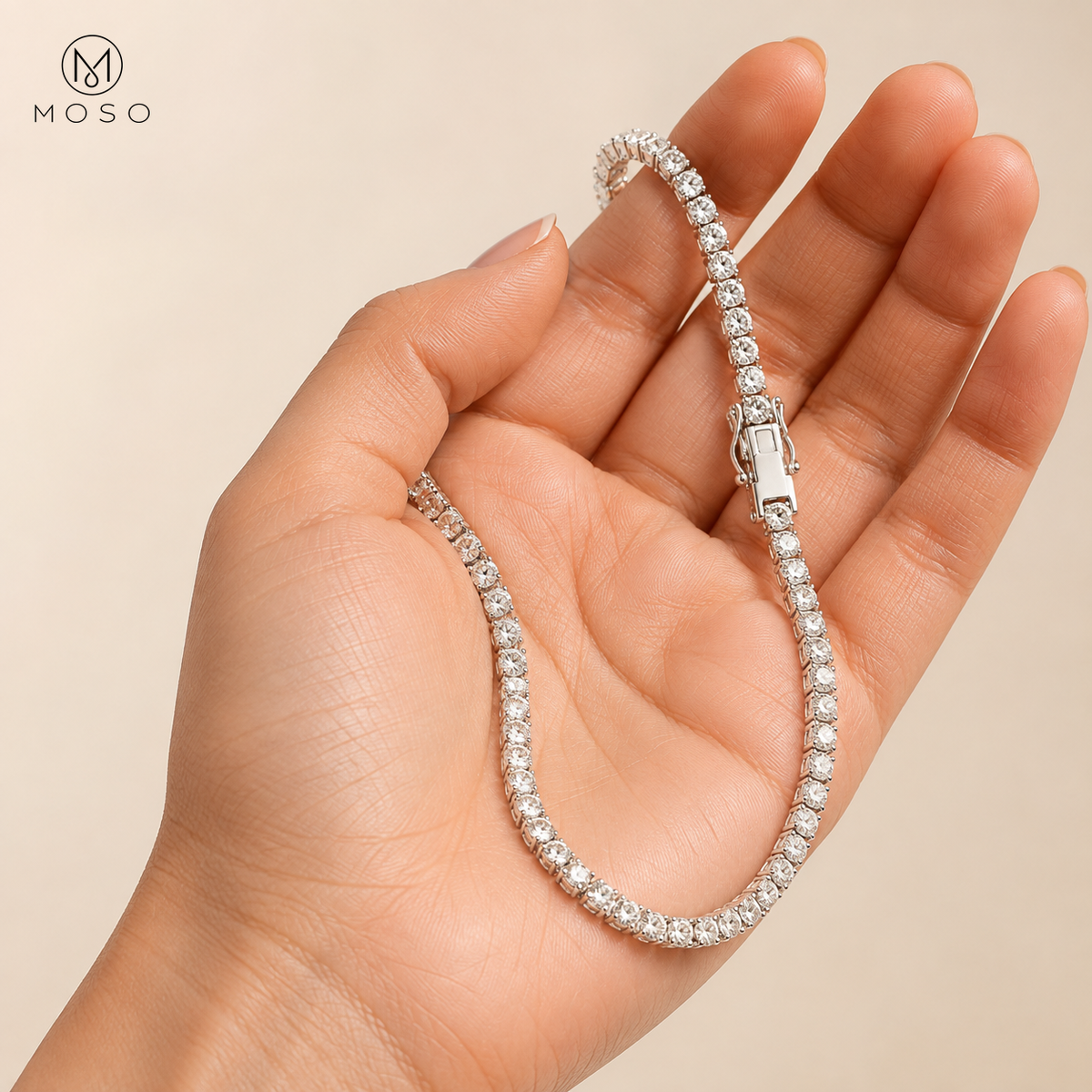 Addison moissanite tennis bracelet held in an adult hand