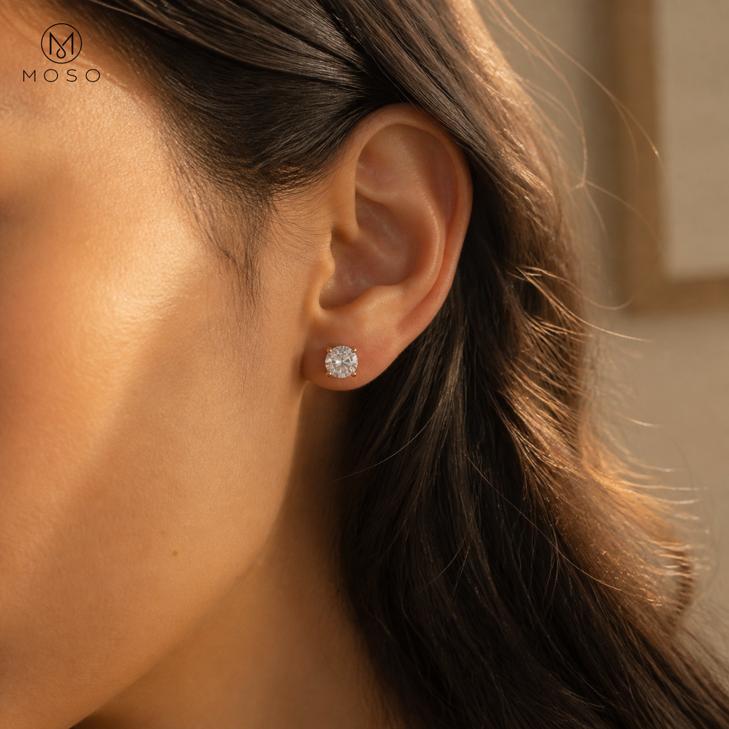 Amelia rose gold tone round moissanite stud earring worn on the ear