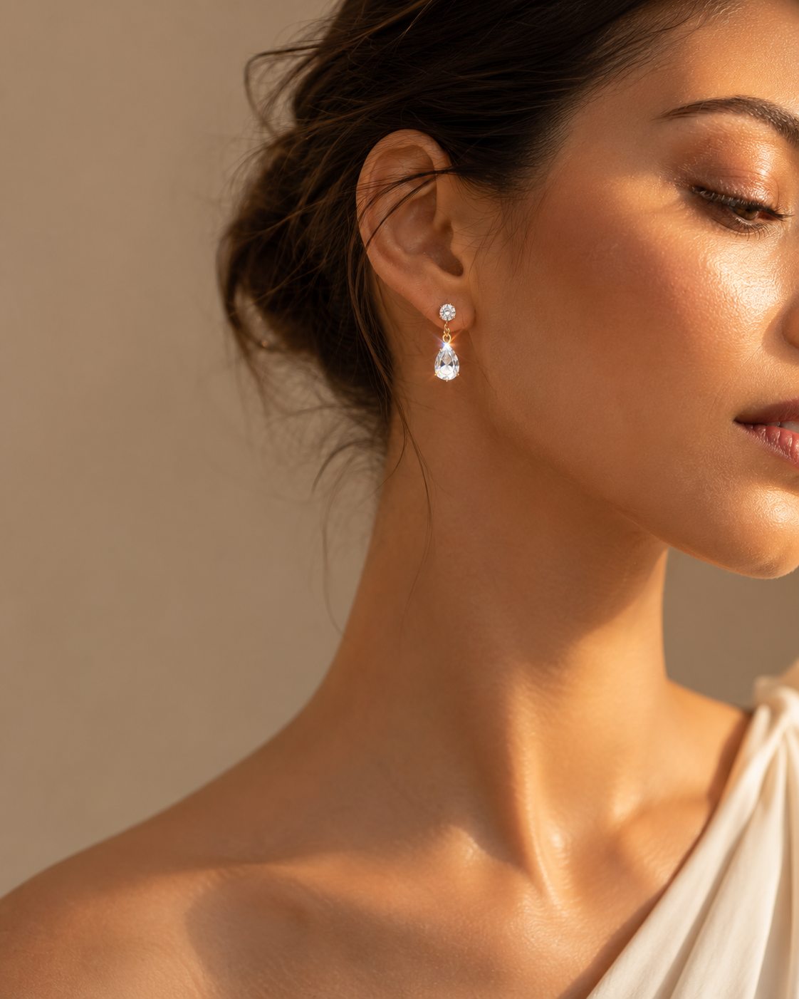 Close-up of a pear-shaped drop earring worn beside the face