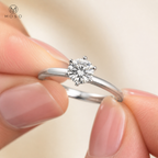 Charlotte six prong moissanite ring held in hand