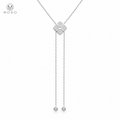 Chloe moissanite four petal lariat necklace in silver tone on white