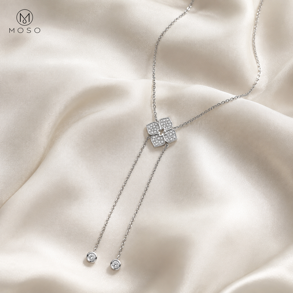 Chloe moissanite lariat necklace arranged on ivory silk