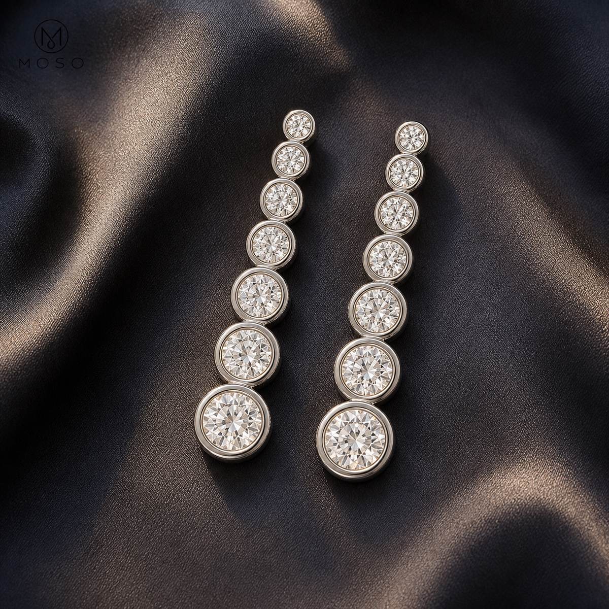 Eliana long silver moissanite drop earrings on dark satin