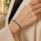 Woman wearing Ellie royal blue 3 mm moissanite tennis bracelet