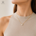 Emily gold colour round moissanite necklace worn with a neutral top