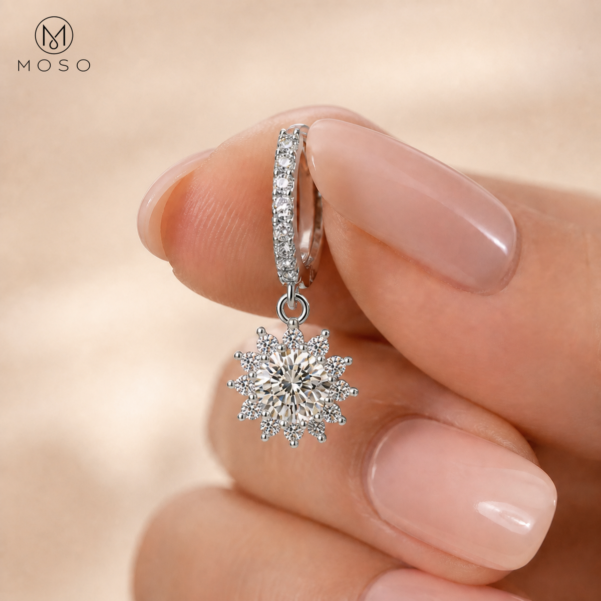 Evelyn sterling silver moissanite drop earring held by hand, scale detail | MOSO