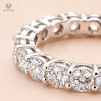 Close view of Hailey round moissanite stones and open four prong eternity setting