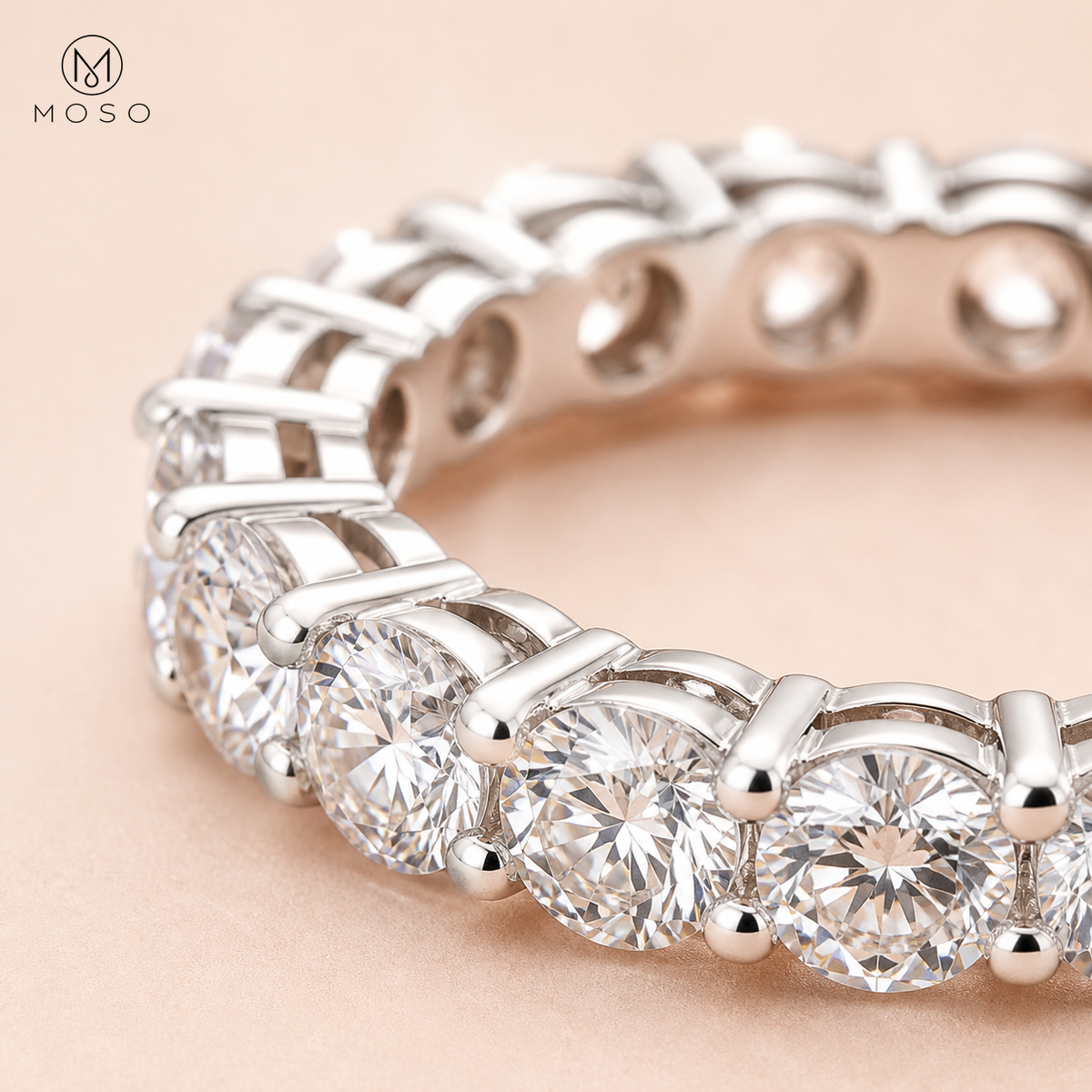 Close view of Hailey round moissanite stones and open four prong eternity setting