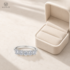 Harper moissanite wedding band beside an ivory jewelry box
