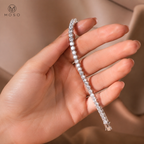 Lauren 5mm moissanite tennis bracelet draped over a hand