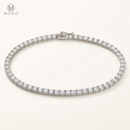 Layla clear round stone tennis necklace on ivory background