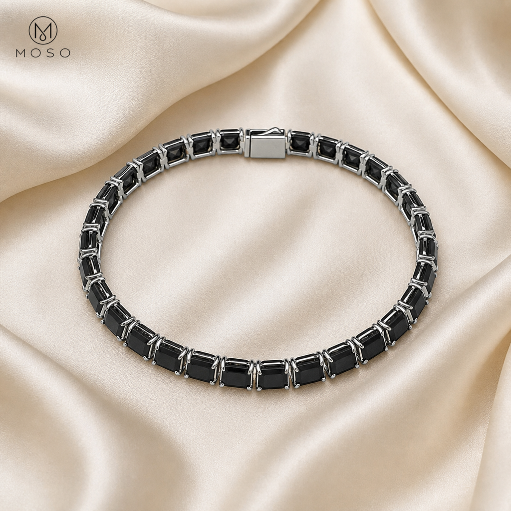 Lucy black moissanite tennis bracelet flat lay on ivory silk
