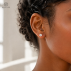 Mia round moissanite stud earring worn beside soft window light