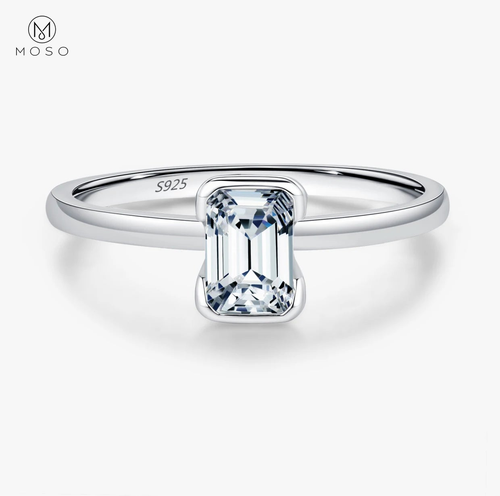 Complete emerald-cut moissanite sterling silver ring centered on a clean white background