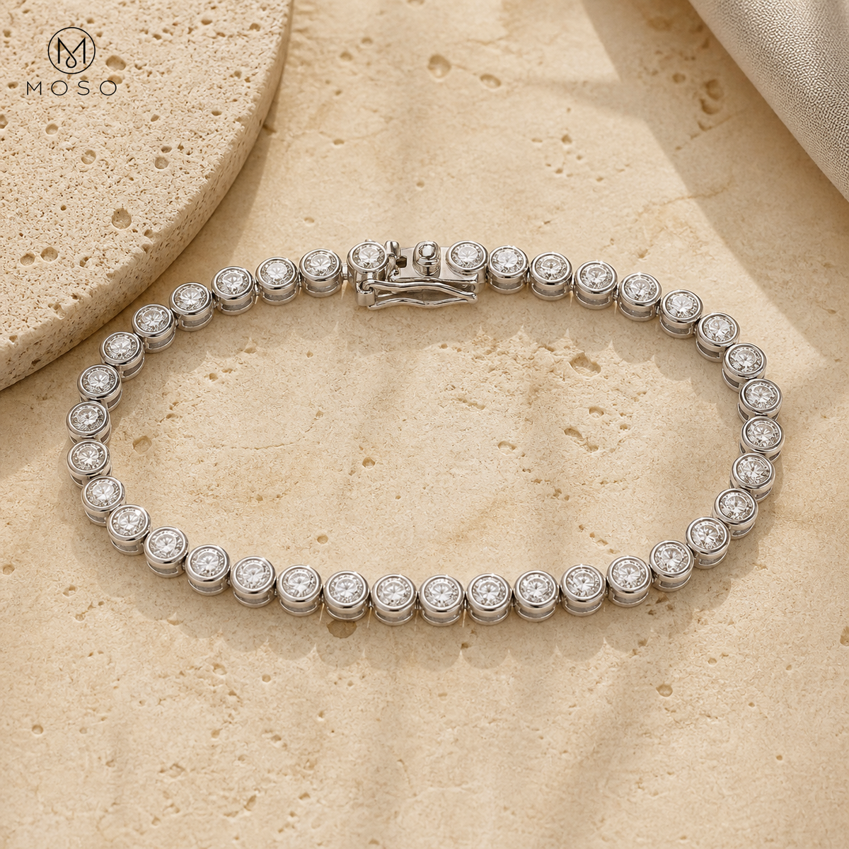 Naomi 3 mm moissanite bezel tennis bracelet on travertine