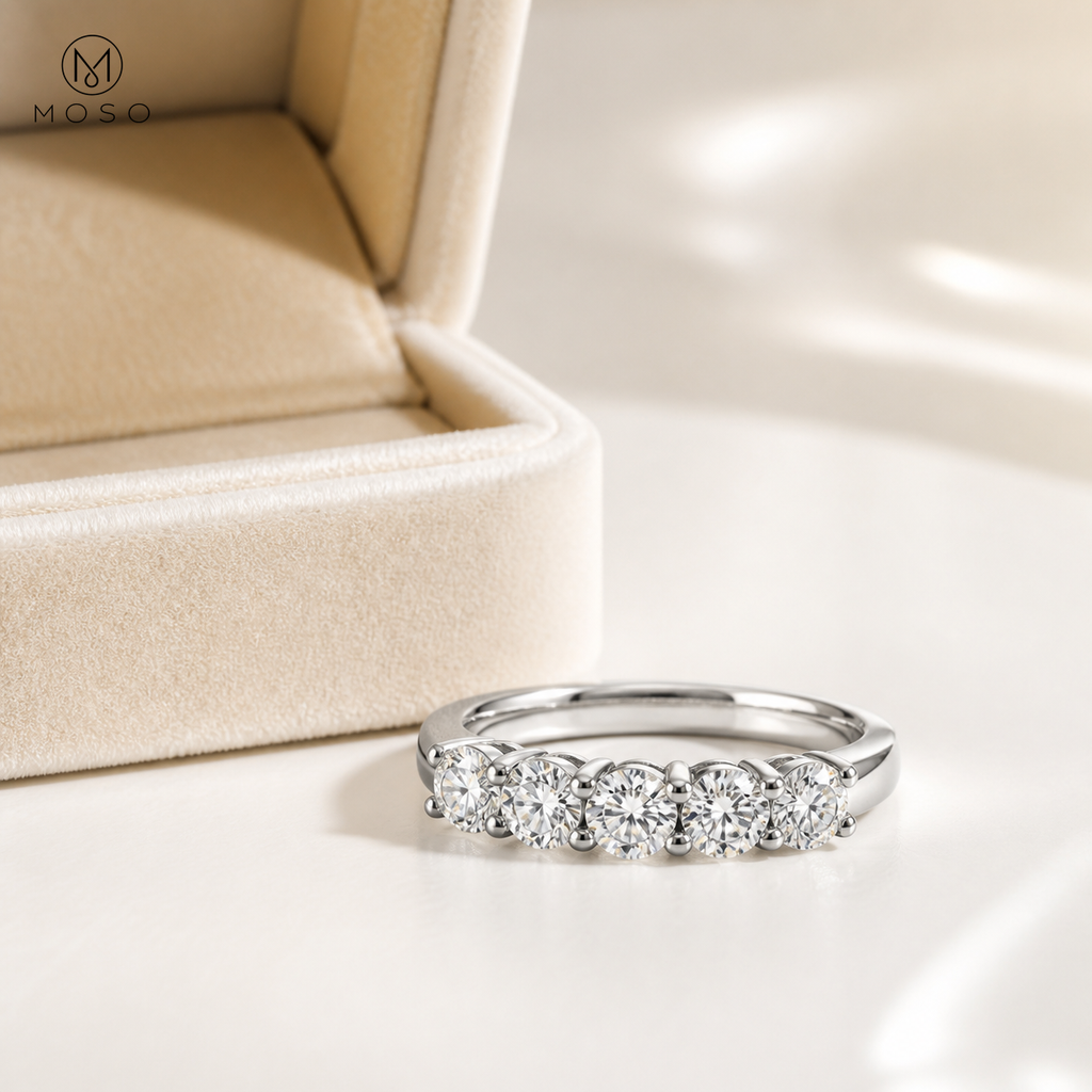 Natalie moissanite wedding band beside cream jewellery box