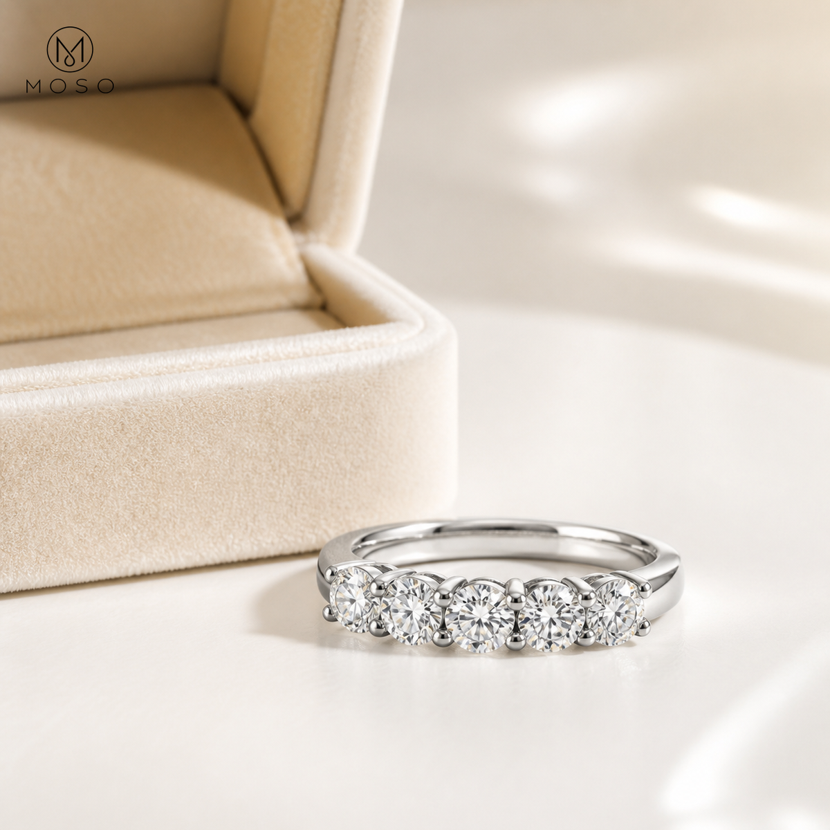 Natalie moissanite wedding band beside cream jewellery box