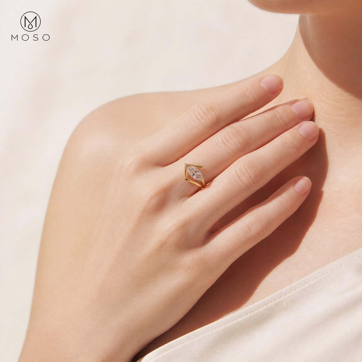 Woman wearing Olivia gold tone marquise moissanite ring