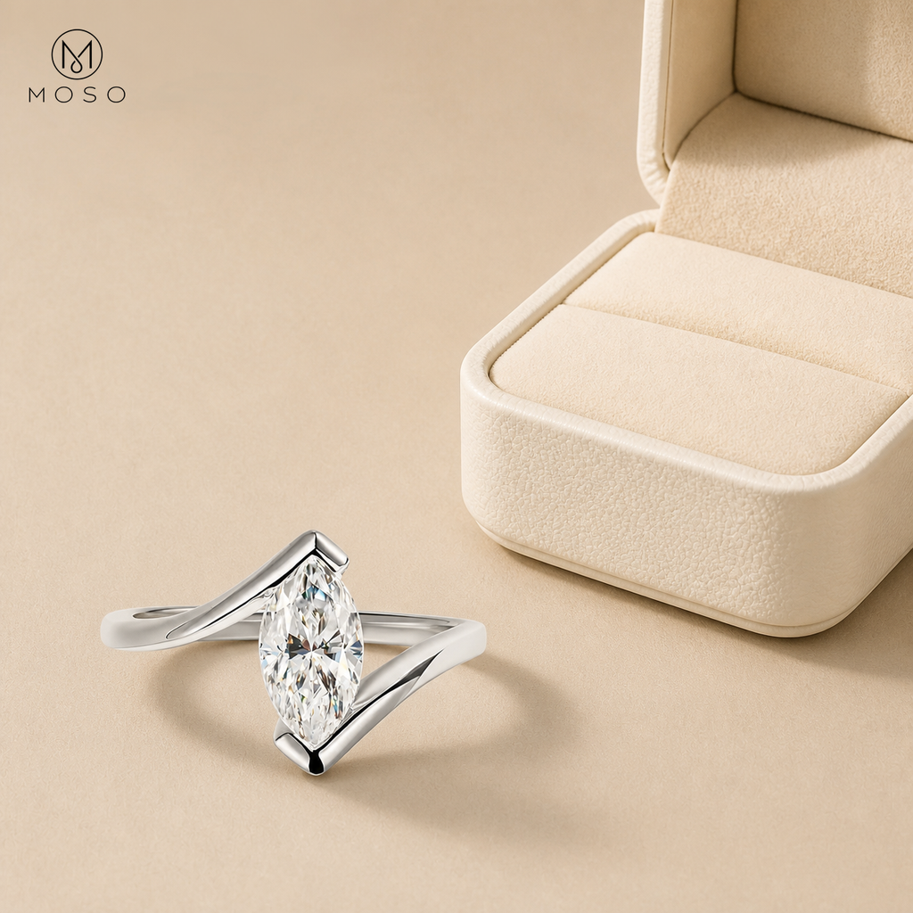 Olivia marquise moissanite ring beside an ivory jewelry box