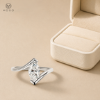 Olivia marquise moissanite ring beside an ivory jewelry box