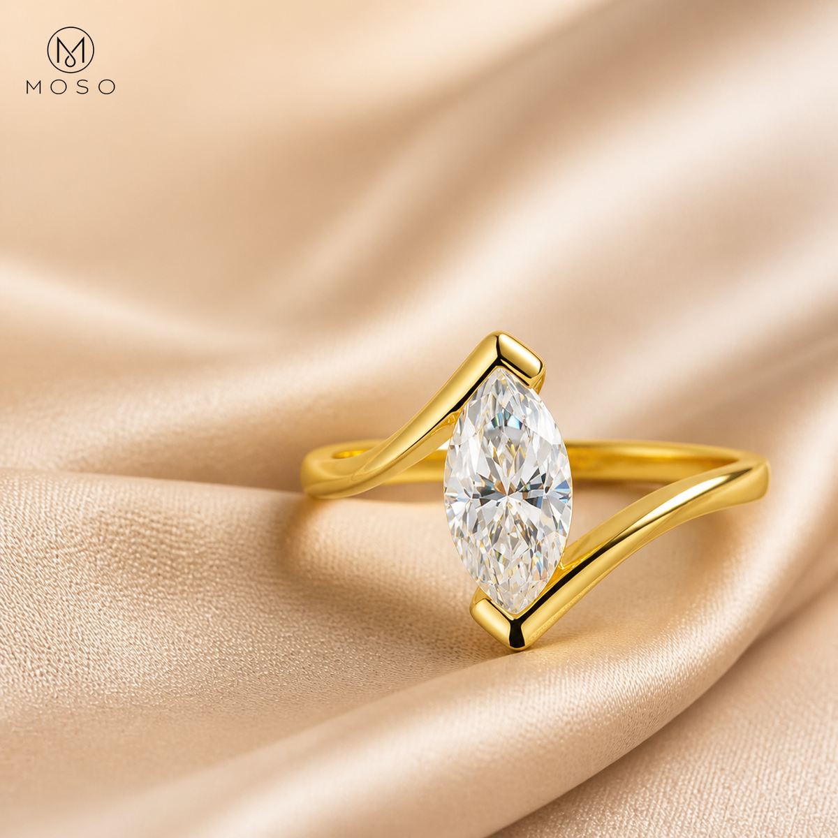 Olivia gold tone marquise moissanite ring on champagne silk