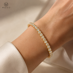 Samantha 4mm gold tone moissanite tennis bracelet worn on an adult wrist