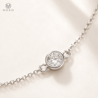 Close view of Savannah round bezel set moissanite stone and fine silver tone chain