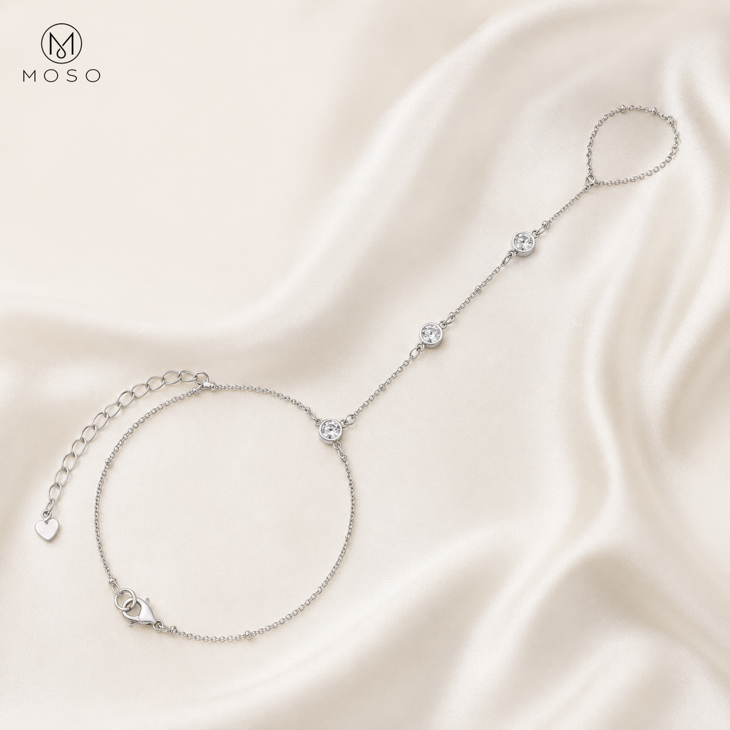 Savannah silver tone moissanite hand chain bracelet arranged on ivory silk