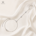 Savannah silver tone moissanite hand chain bracelet arranged on ivory silk