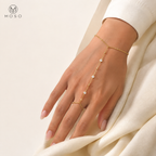 Savannah gold tone moissanite hand chain bracelet worn on an adult hand