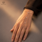 Savannah rose gold tone moissanite hand chain bracelet worn on an adult hand