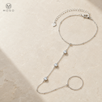 Savannah silver tone hand chain bracelet with three bezel set moissanite stones on pale stone