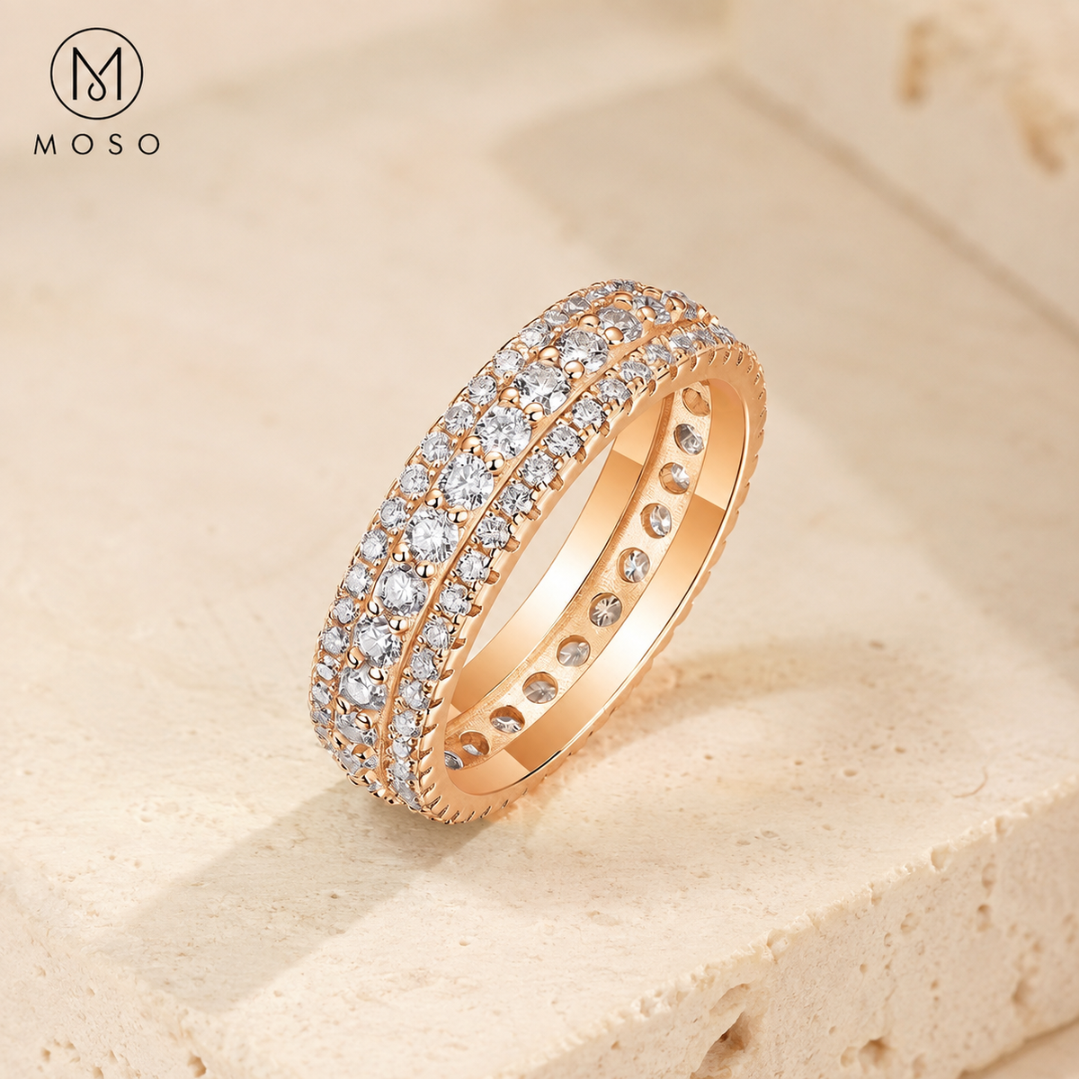 Scarlett rose gold tone moissanite eternity ring on ivory pedestal