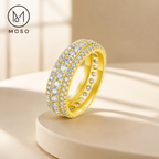Scarlett yellow gold tone moissanite eternity ring on ivory pedestal