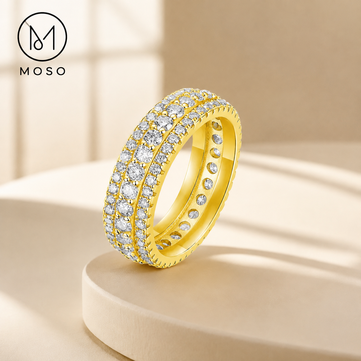 Scarlett yellow gold tone moissanite eternity ring on ivory pedestal